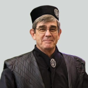 KTU Honorary Doctor Henry William Chesbrough following an honorary doctorate award ceremony. In the photograph, he is wearing academic ceremonial robes and a cap while looking towards the camera.