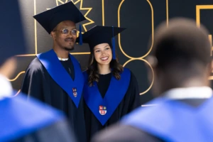 Mariandree Espinoza Aragon1 KTU international students posing in the front of a photowall during graduation