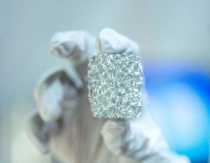 a piece of sponge-like material held by a gloved hand