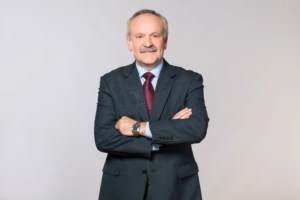 Man in a suit against a grey background
