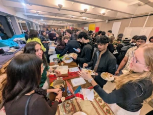 international students sharing national food in a university corridor