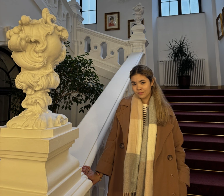 Photo, showing student Arailym Abilova in a staircase