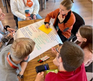 students sitting around a table during a team activity